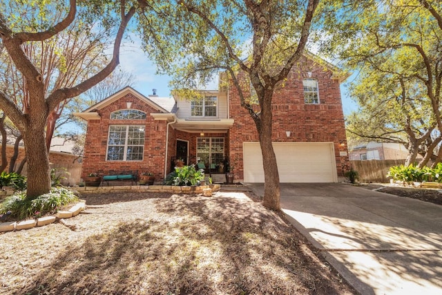 traditional home with driveway, brick siding, an attached garage, and fence