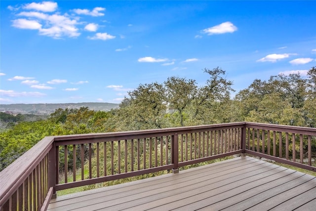 wooden deck featuring a view of trees