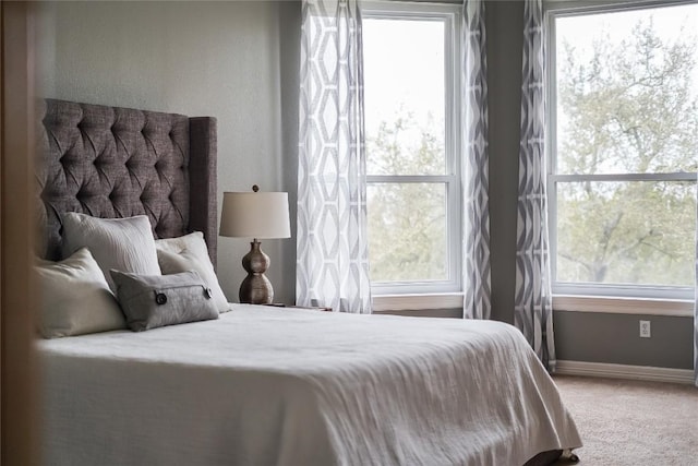 carpeted bedroom featuring baseboards