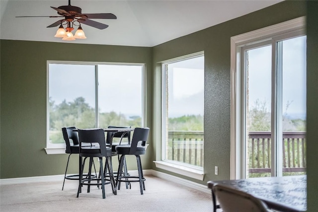 dining area with vaulted ceiling, carpet, a ceiling fan, and baseboards