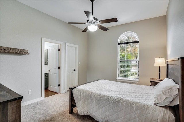 bedroom featuring a ceiling fan, carpet, connected bathroom, and baseboards