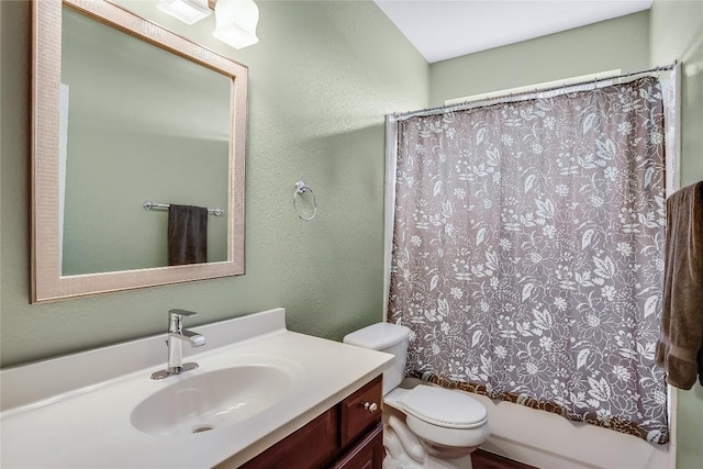 full bath featuring a textured wall, vanity, toilet, and shower / tub combo with curtain