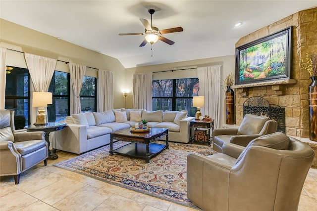 living room with ceiling fan, a fireplace, and vaulted ceiling