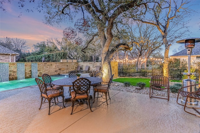 view of patio featuring fence and outdoor dining space