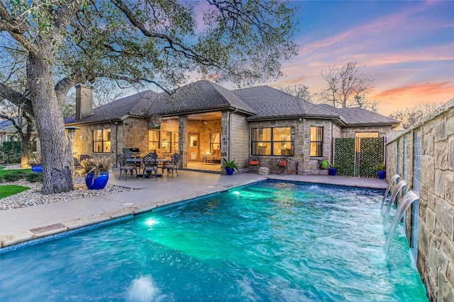 view of swimming pool featuring a patio, fence, and a fenced in pool