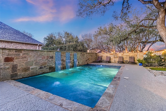 view of swimming pool with a fenced in pool, fence, and a patio