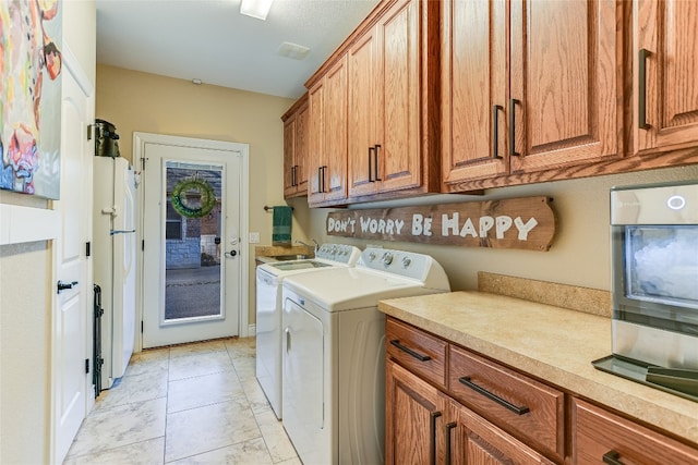 laundry area with cabinet space and washing machine and dryer