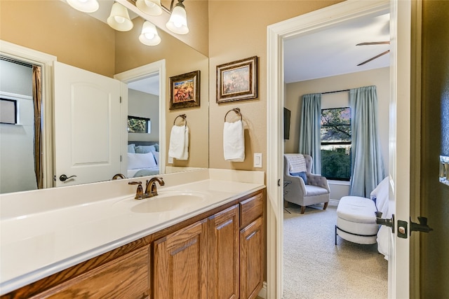 ensuite bathroom with connected bathroom, vanity, and a notable chandelier