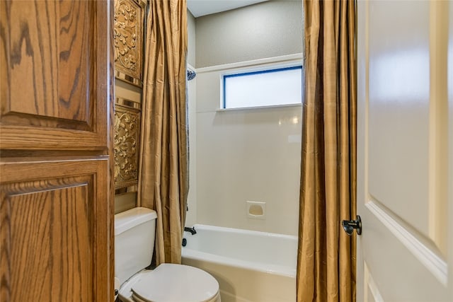 full bathroom with shower / bath combo with shower curtain and toilet