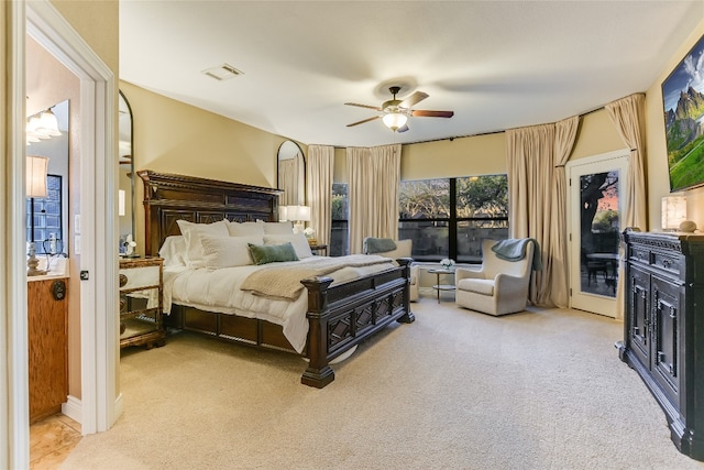 bedroom with access to exterior, light carpet, visible vents, and a ceiling fan