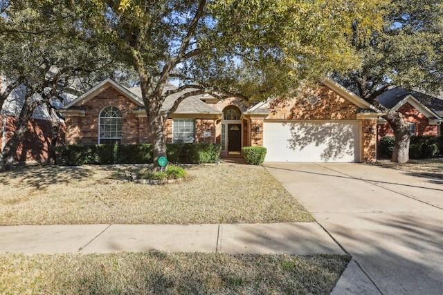 single story home featuring an attached garage, a front lawn, concrete driveway, and brick siding