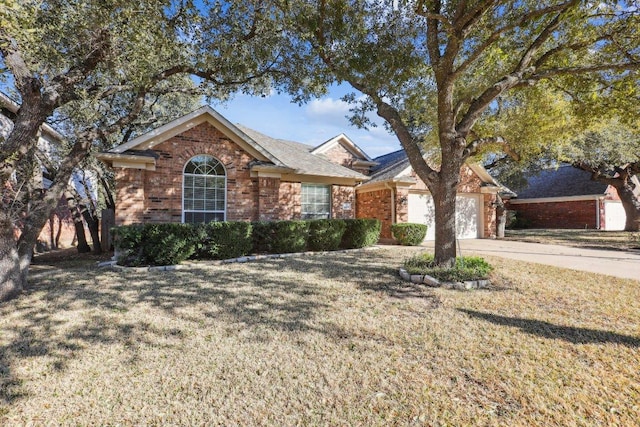 single story home with a garage, driveway, a front yard, and brick siding