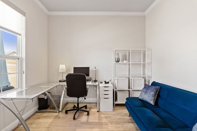 home office with crown molding, light wood-style flooring, and baseboards