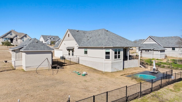 193 Raptor Beak Way, Cedar Creek, TX 78612 - rear view of property featuring stucco siding, a fenced backyard, and roof with shingles