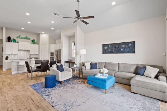 193 Raptor Beak Way, Cedar Creek, TX 78612 - living area with light wood-style flooring, ceiling fan, vaulted ceiling, and recessed lighting