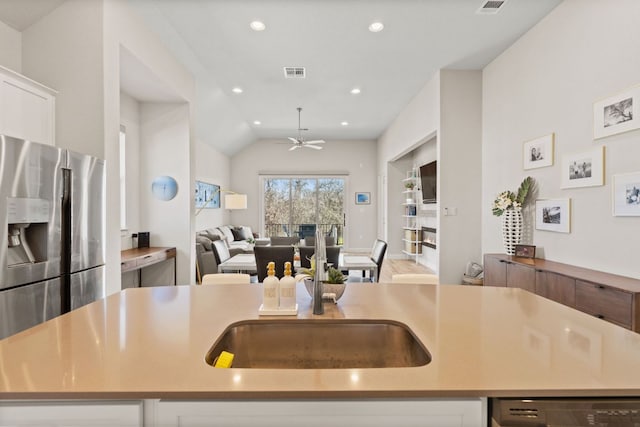 kitchen featuring visible vents, open floor plan, light countertops, stainless steel fridge with ice dispenser, and dishwasher