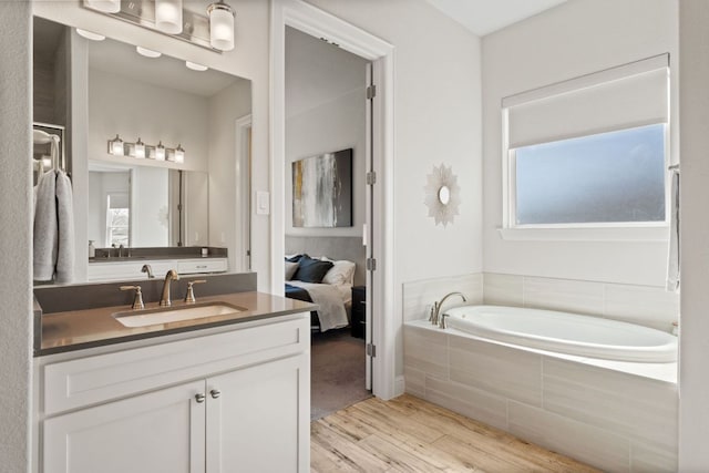 193 Raptor Beak Way, Cedar Creek, TX 78612 - full bathroom with wood finished floors, vanity, and a garden tub