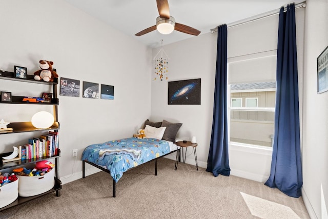 carpeted bedroom with baseboards and a ceiling fan