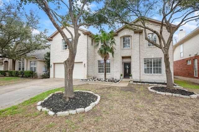 traditional home with a garage, stone siding, and driveway