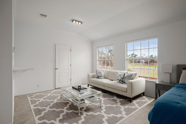 living area featuring carpet floors, lofted ceiling, visible vents, and ornamental molding