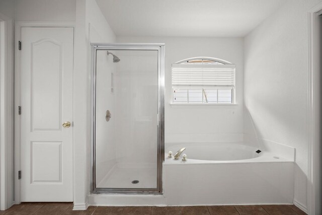 full bathroom featuring a stall shower, tile patterned flooring, and a bath