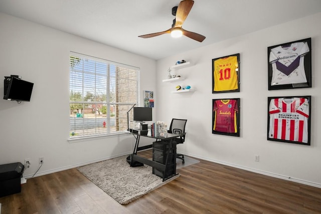 office area featuring ceiling fan, baseboards, and wood finished floors