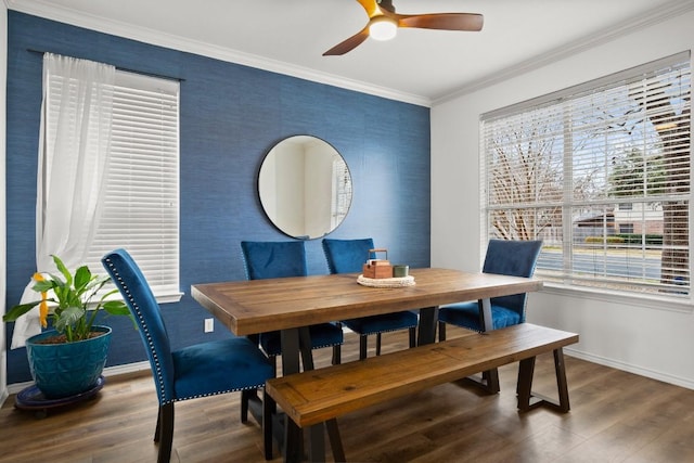 dining room with a ceiling fan, baseboards, ornamental molding, and wood finished floors