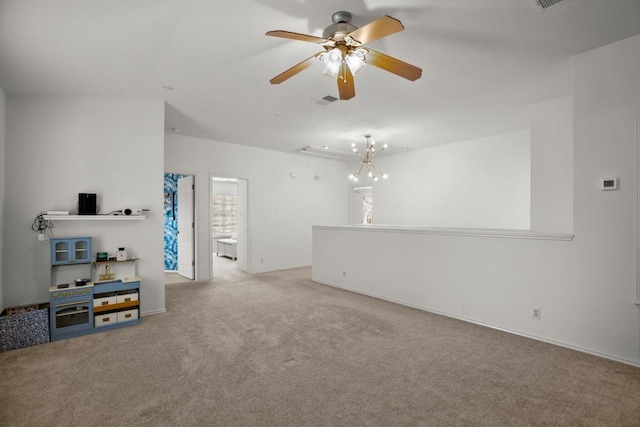 living area featuring carpet, visible vents, and ceiling fan