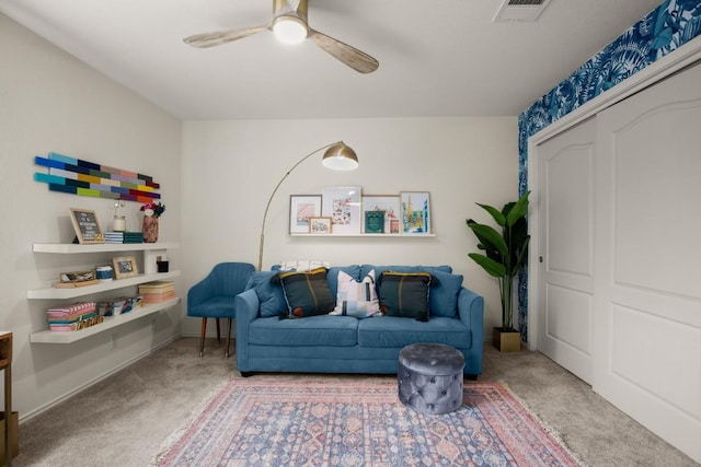 sitting room with a ceiling fan, baseboards, visible vents, and carpet flooring