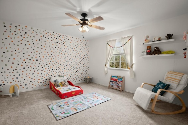 game room with carpet floors, ceiling fan, and baseboards