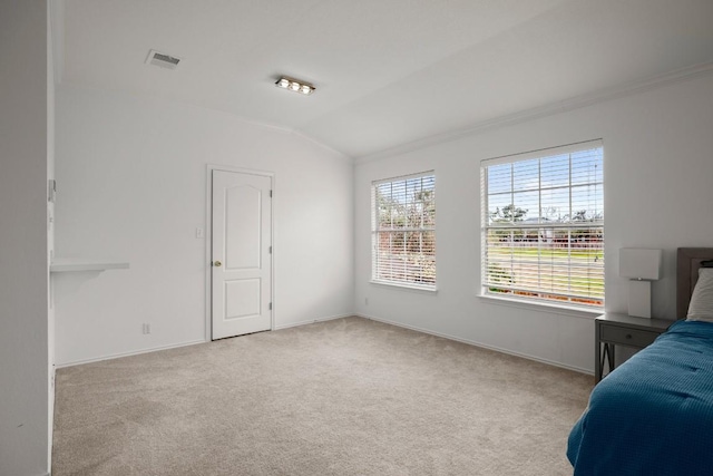 unfurnished bedroom featuring lofted ceiling, carpet flooring, visible vents, and baseboards