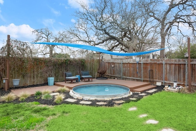 view of pool featuring a hot tub, fence, a lawn, and a patio