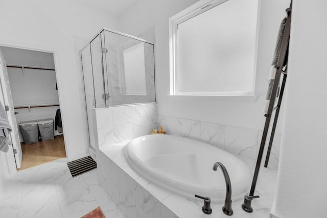 bathroom featuring a marble finish shower, visible vents, marble finish floor, a spacious closet, and a bath