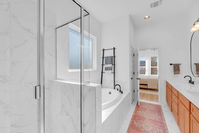 bathroom featuring a marble finish shower, visible vents, ensuite bath, vanity, and a bath