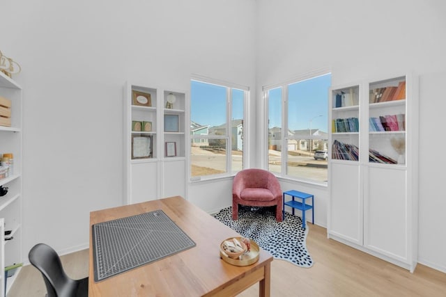 office space featuring light wood-style flooring and baseboards