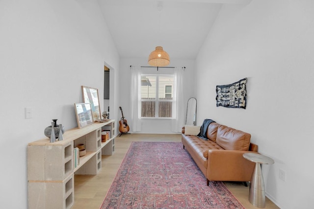 living area featuring lofted ceiling and light wood-style flooring