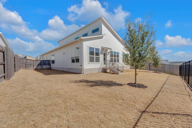 back of house featuring a fenced backyard