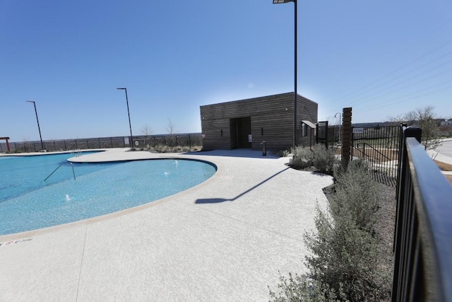 pool with fence and a patio