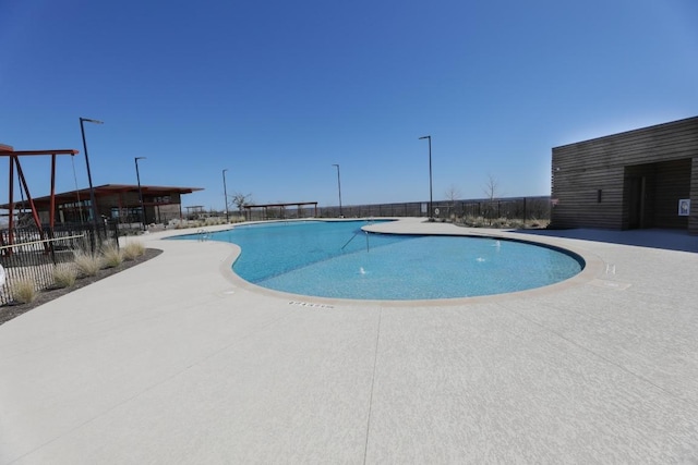 pool with fence and a patio