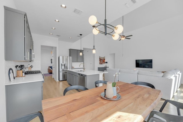 dining area featuring ceiling fan with notable chandelier, recessed lighting, visible vents, and light wood-style floors