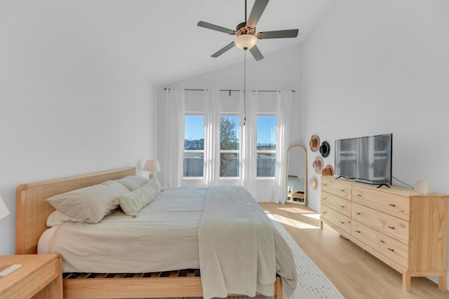 bedroom featuring light wood-style floors, ceiling fan, and high vaulted ceiling