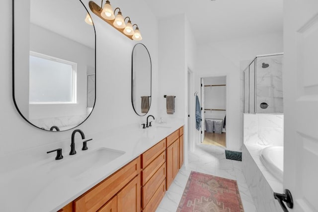 bathroom featuring a garden tub, a sink, marble finish floor, double vanity, and a shower with door