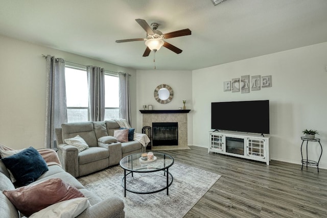 13505 Abraham Lincoln St, Manor, TX 78653 - living area featuring a fireplace, ceiling fan, wood finished floors, and baseboards