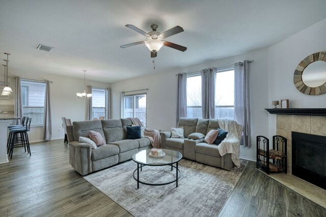 13505 Abraham Lincoln St, Manor, TX 78653 - living room featuring wood finished floors, a ceiling fan, a chandelier, and baseboards