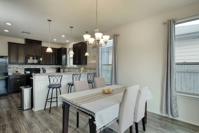 13505 Abraham Lincoln St, Manor, TX 78653 - dining room featuring a chandelier, dark wood finished floors, recessed lighting, and baseboards