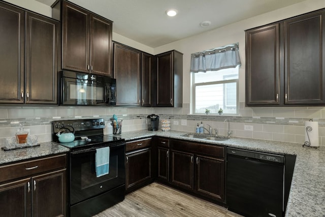 13505 Abraham Lincoln St, Manor, TX 78653 - kitchen featuring black appliances, a sink, tasteful backsplash, and light stone countertops