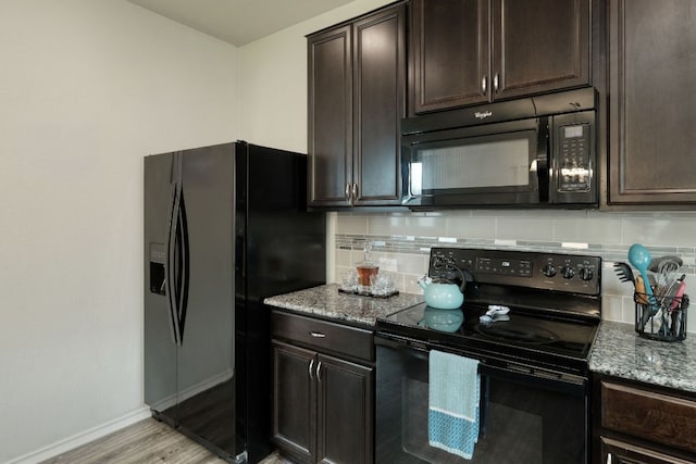 13505 Abraham Lincoln St, Manor, TX 78653 - kitchen with black appliances, backsplash, light stone counters, baseboards, and dark brown cabinetry