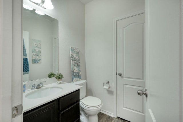 13505 Abraham Lincoln St, Manor, TX 78653 - half bath with vanity, toilet, and wood finished floors