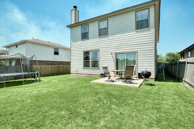 13505 Abraham Lincoln St, Manor, TX 78653 - back of property featuring a trampoline, a chimney, and a patio