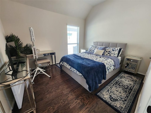 bedroom featuring vaulted ceiling and wood finished floors